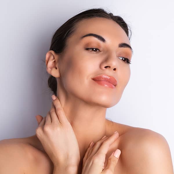 A woman admiring her new look after a facelift procedure